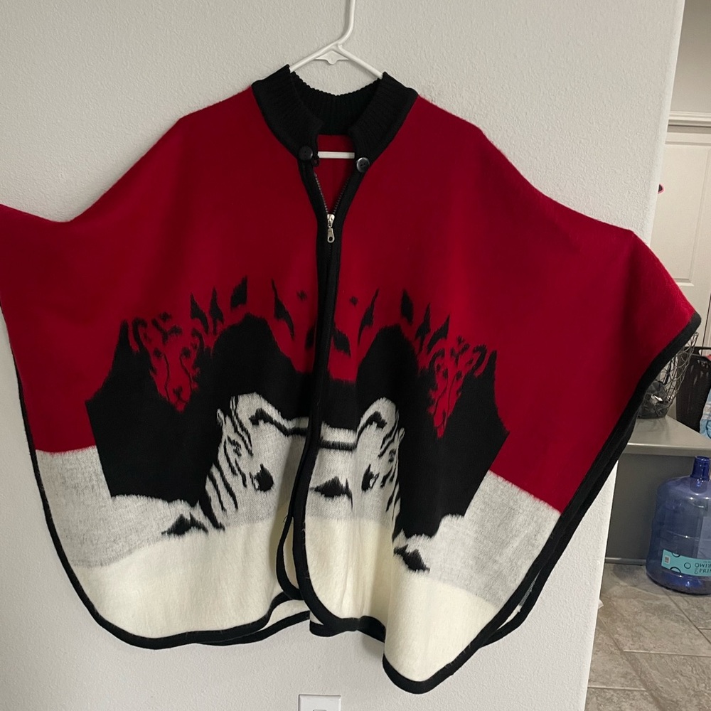 Red, black and white poncho.